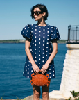 Red rattan crab handbag styled with Byrdie Golf Social