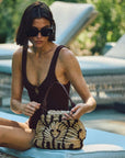 Artisan jute tote bag in mini silhouette with woven rope design - styled on a model poolside - The Rope Tote