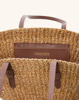 Handwoven mini tote bag with interior leather pocket and charm