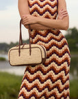Woven raffia bowler bag with leather trim styled on a model – The Bowler Bag
