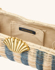 Interior detail of rattan clutch with gold seashell clasp