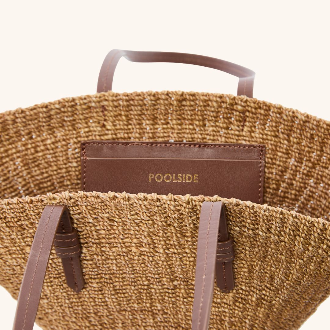 Handwoven mini tote bag with interior leather pocket and charm