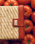 Rattan vanity case in front of tomatoes