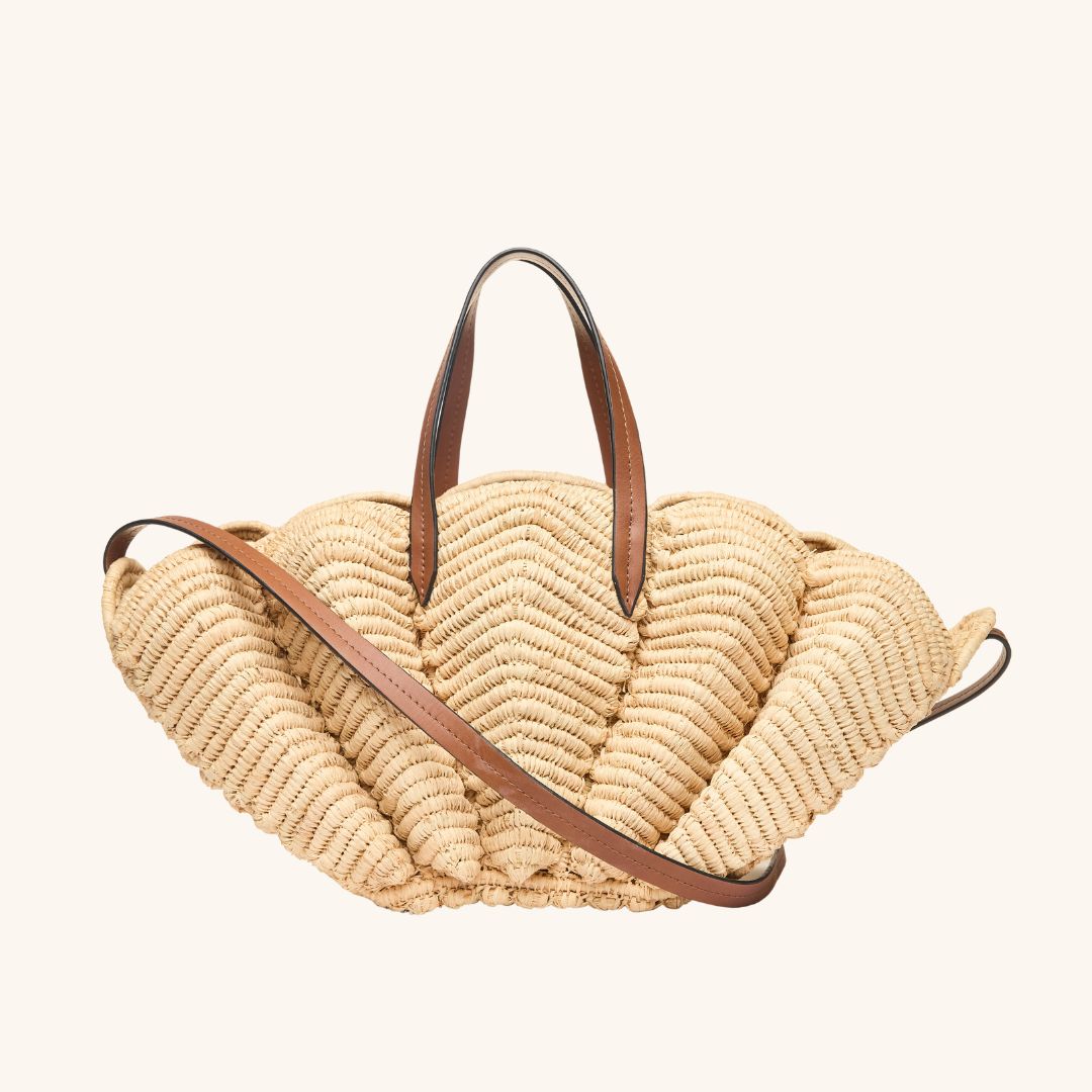 Handwoven raffia beach tote in scallop shell shape with crossbody strap