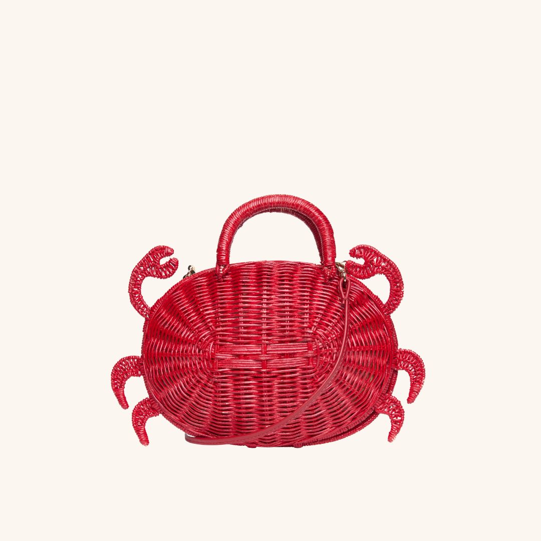 Red rattan crossbody bag shown with leather strap — playful summer accessory