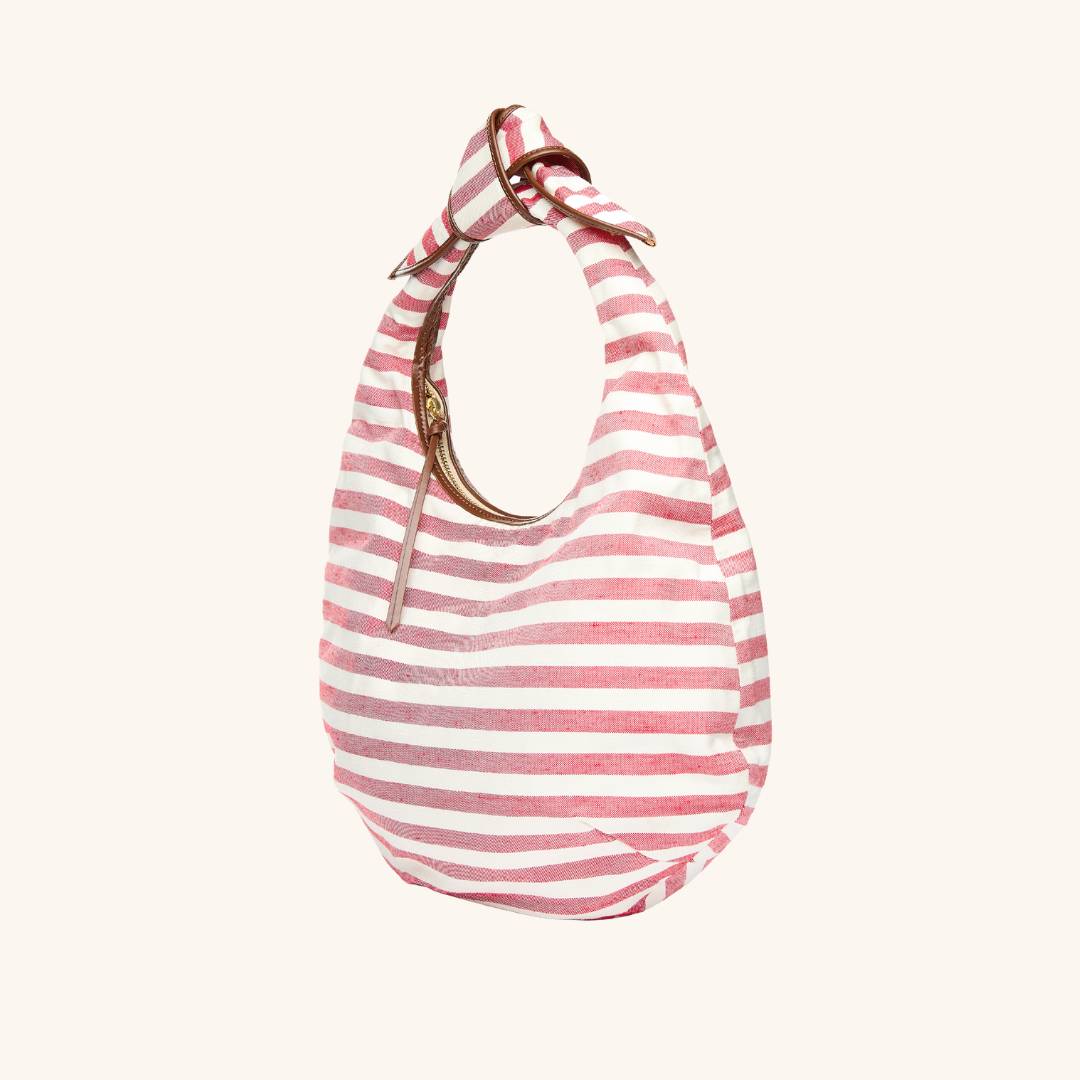 Quarter view - The Josie Knot Bag - Red striped tote bag with structured shape and leather trim