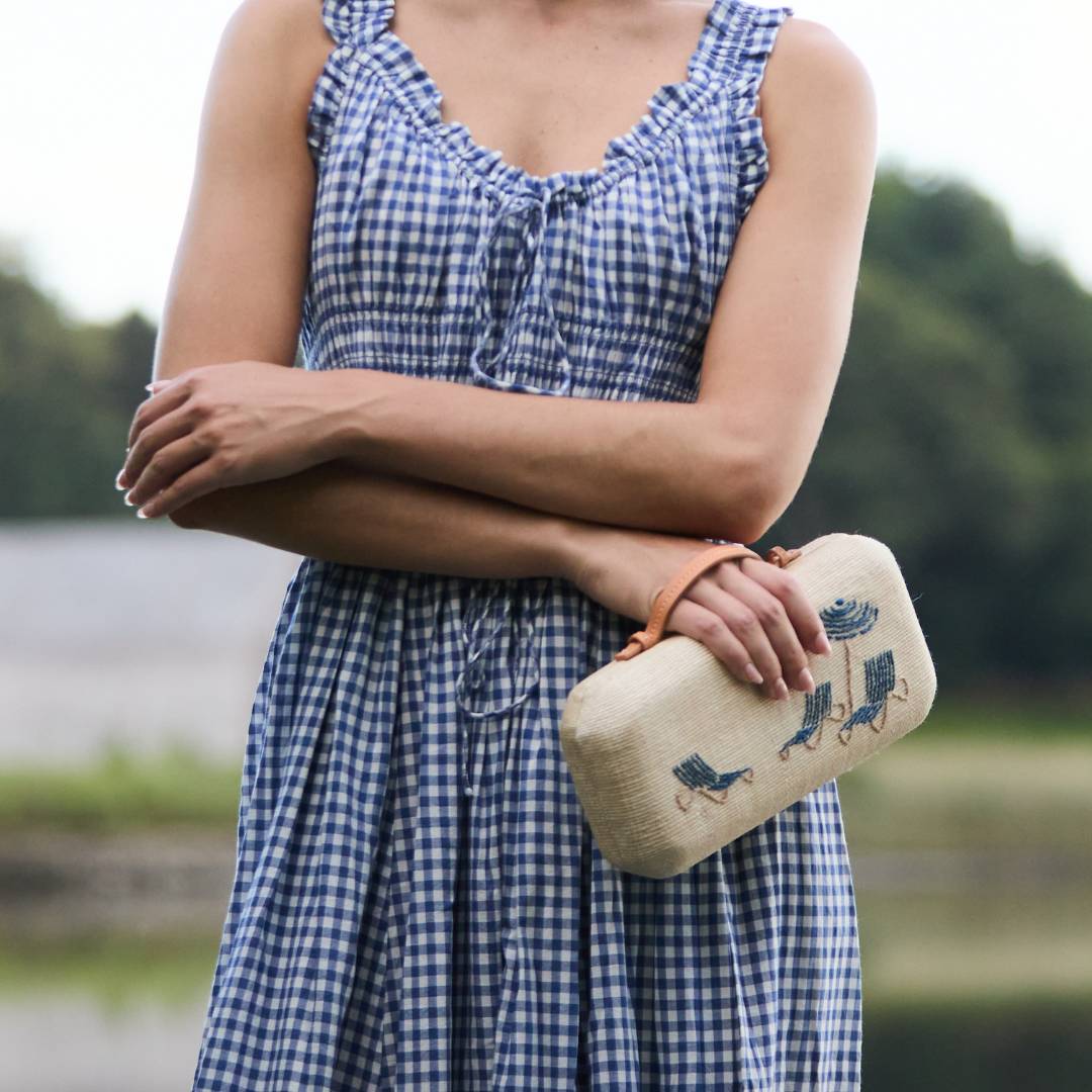 The Deck Chairs Clutch (mediterranean) held by the top handle