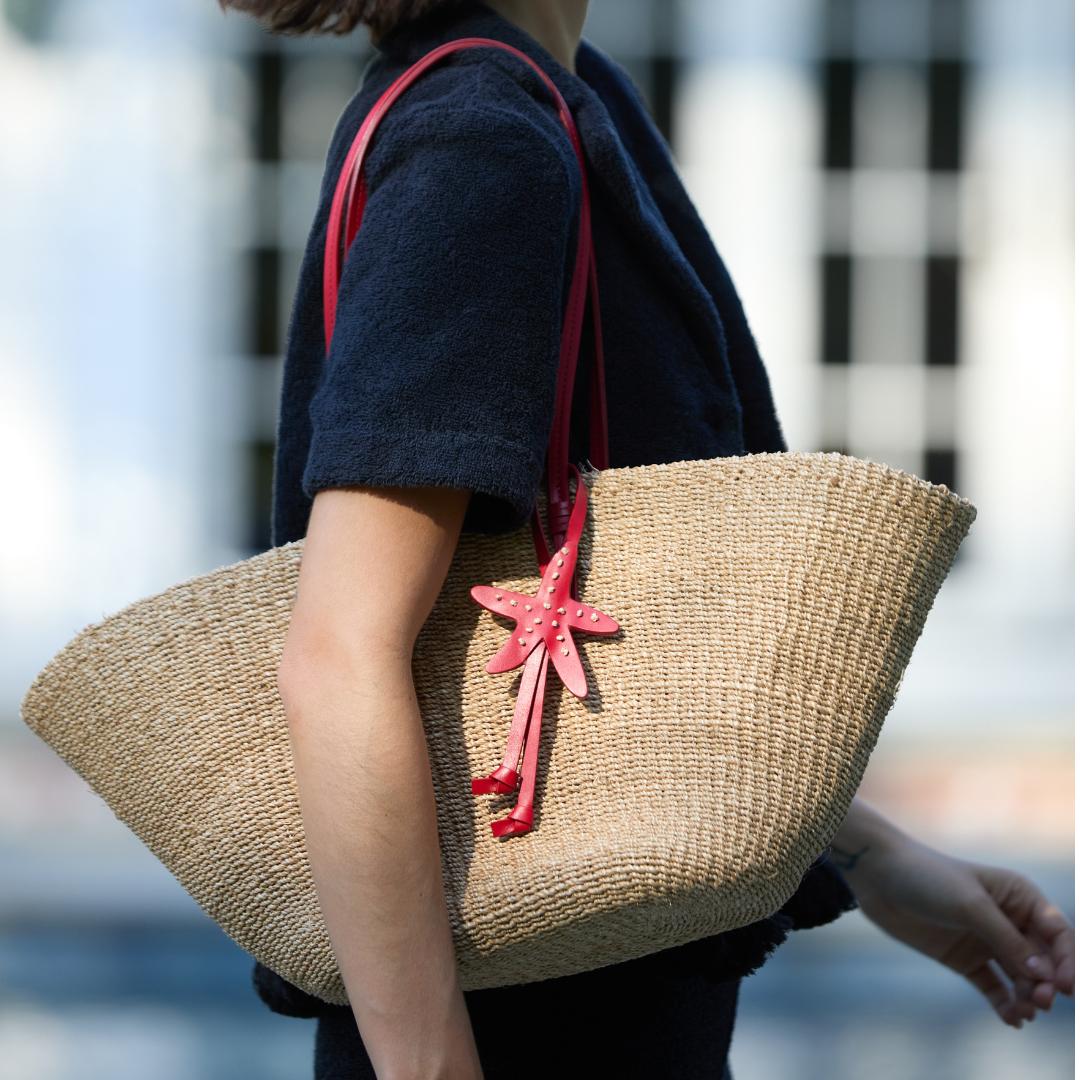 The East West Charm Tote carried on the shoulder