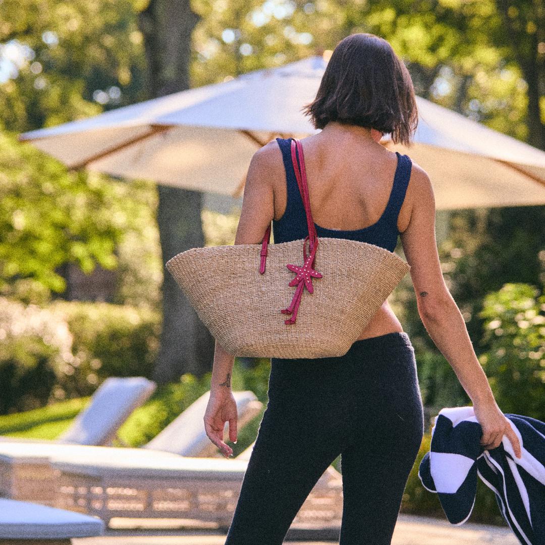 The East West Charm Tote carried on the shoulder