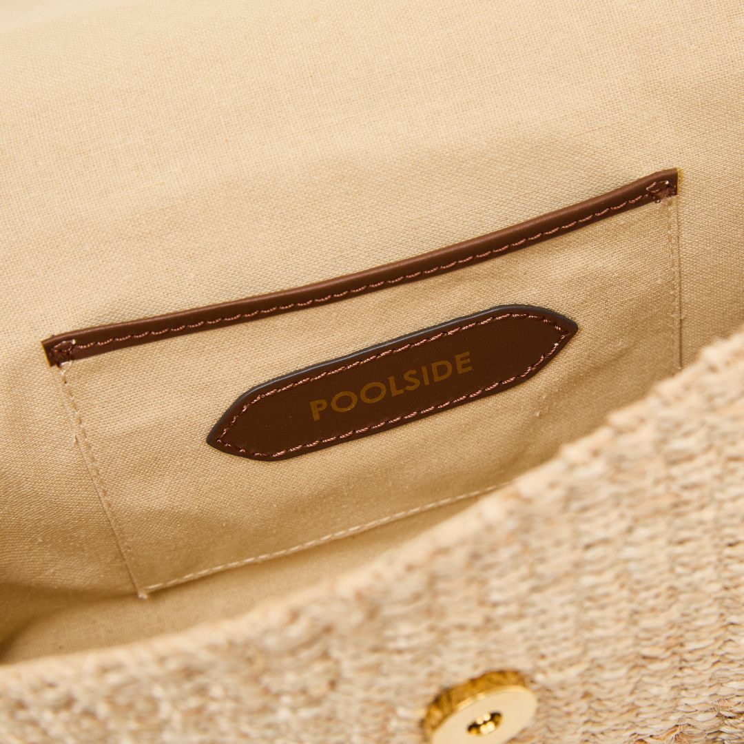 Interior view of The Harper Clutch woven straw clutch