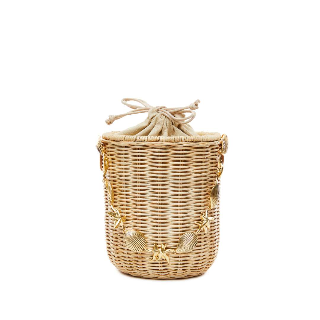 Drawstring closure detail on straw bucket bag