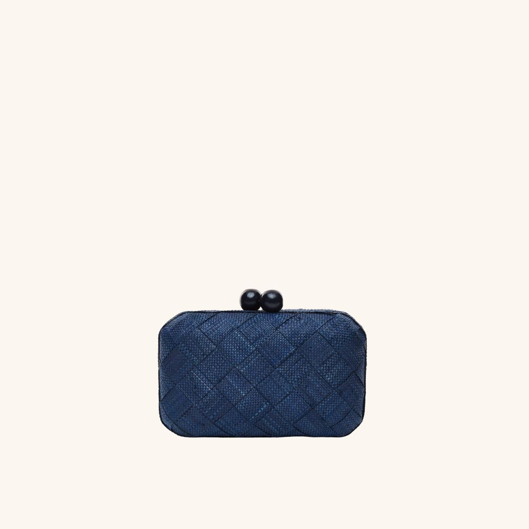 Woven straw clutch in navy with chain strap – The Island Clutch