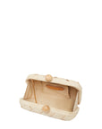 Interior of straw clutch in sand with chain strap – The Island Clutch