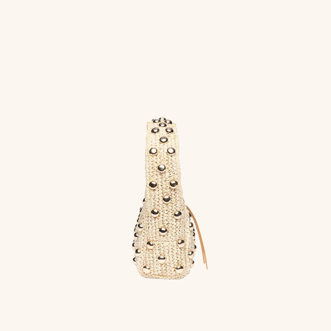 Side view of The Lachlan raffia bag with gold stud accents