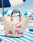 Medium straw beach tote bag on a lounge – The Medium Beach Tote