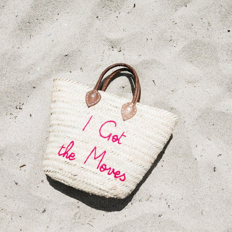 Medium straw beach tote bag on the sand – The Medium Beach Tote