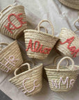 Personalized straw monogram baskets styled for gifting